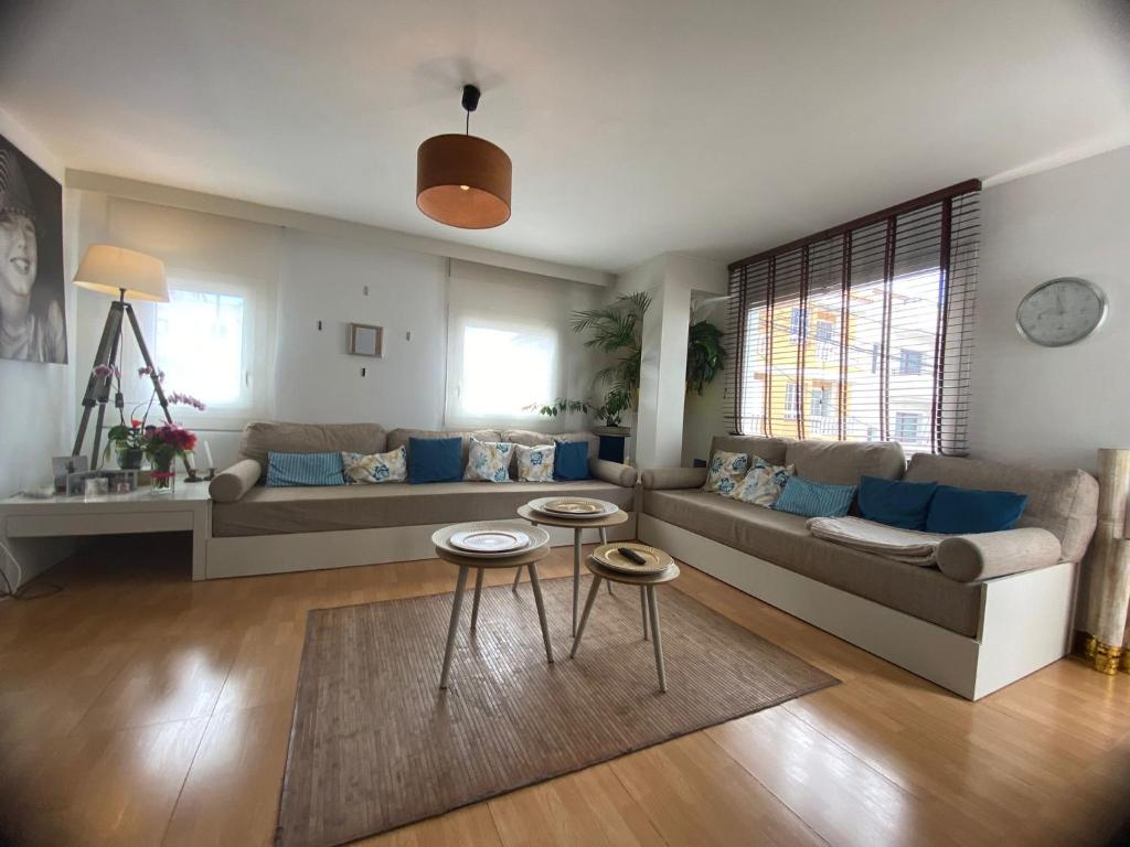 a living room with a couch and two tables at Apartamento caracol in Los Abrigos