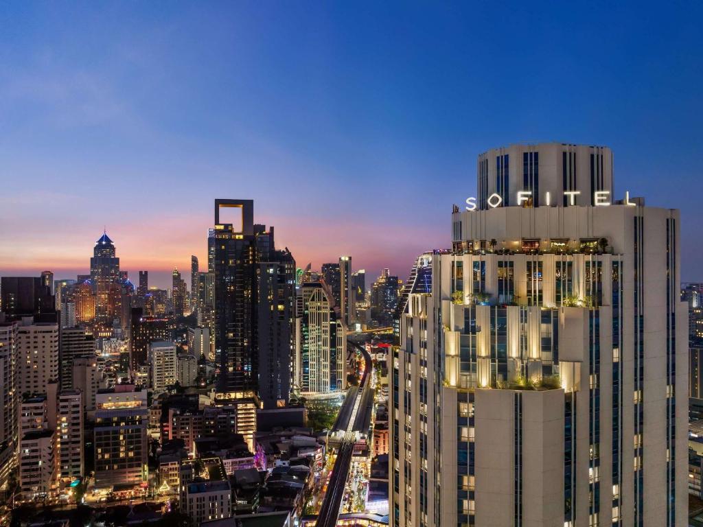 a view of a city skyline at night at Sofitel Bangkok Sukhumvit in Bangkok