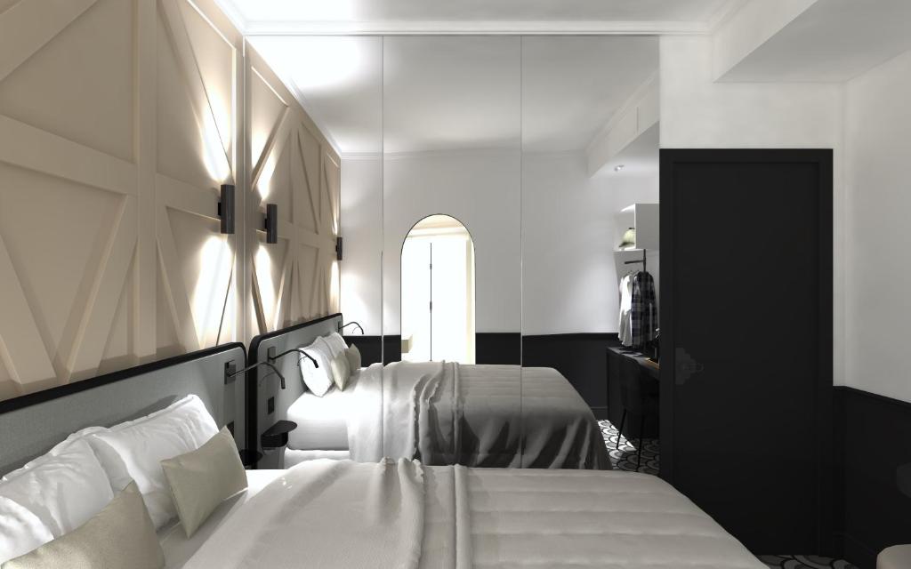 a hotel room with two beds and a mirror at Logis Hotel Darcy Dijon Centre in Dijon