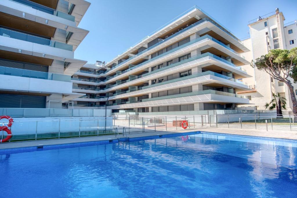 a swimming pool in front of a building at Penthouse on the first line in Platja d'Aro