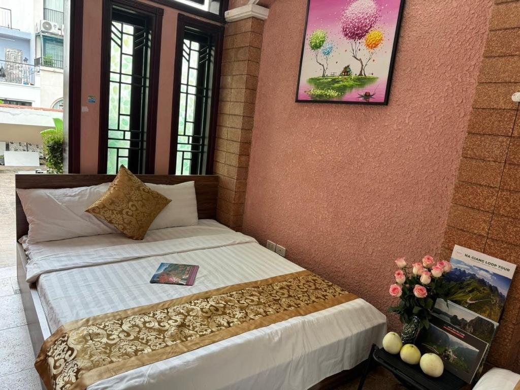 a bedroom with a bed with a picture on the wall at Quynh Moon homestay in Hanoi