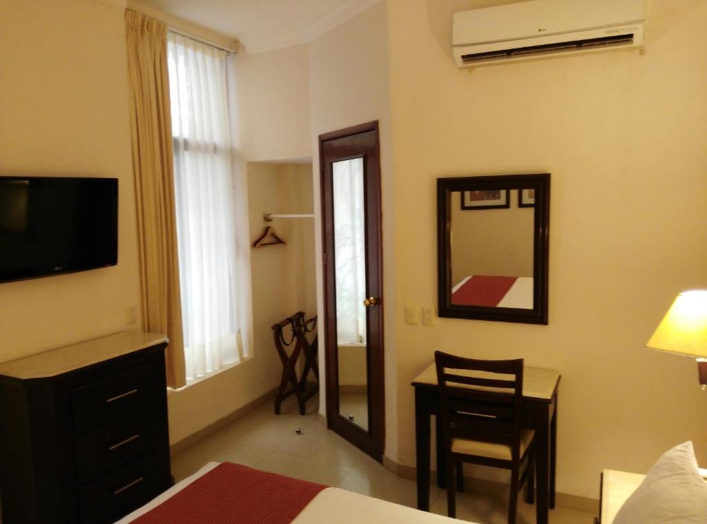 Postel nebo postele na pokoji v ubytování Hotel Lopez Campeche