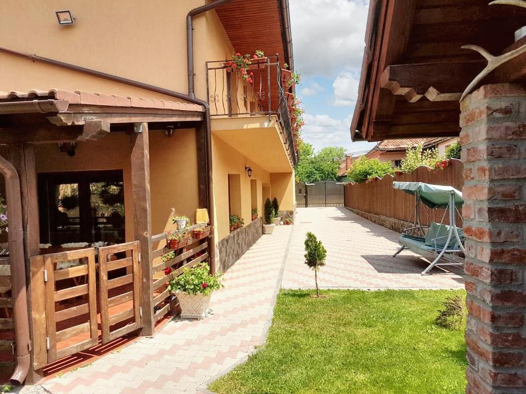 a courtyard of a house with a fence at 3 bedrooms house with furnished terrace and wifi at Sacele in Săcele