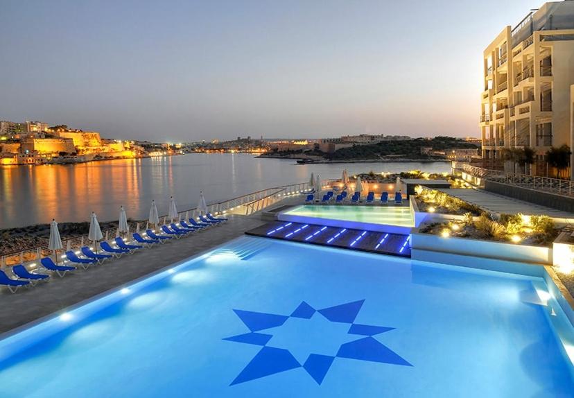 a swimming pool with stars on it next to the water at Stylish Apartment in Tigne Point in Sliema