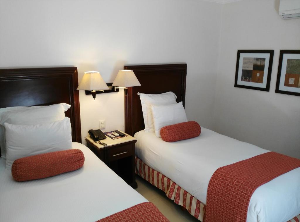 Postel nebo postele na pokoji v ubytování Hotel Lopez Campeche