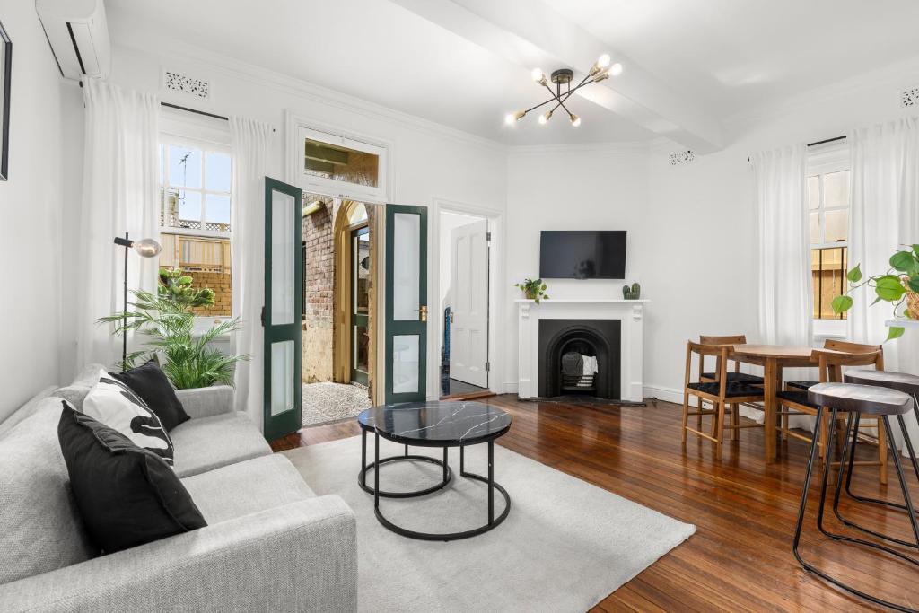 a living room with a couch and a table at Perfect 2BR Harbour View Apartment in Sydney