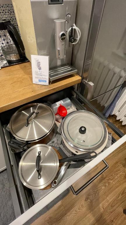 a group of pans sitting on top of a stove at Gdynia Riviera Hills in Gdynia