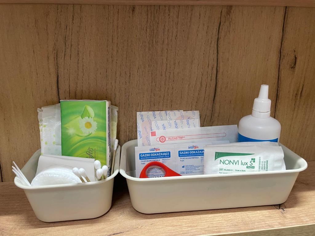 two containers of medicines and a bottle on a table at Gdynia Riviera Hills in Gdynia