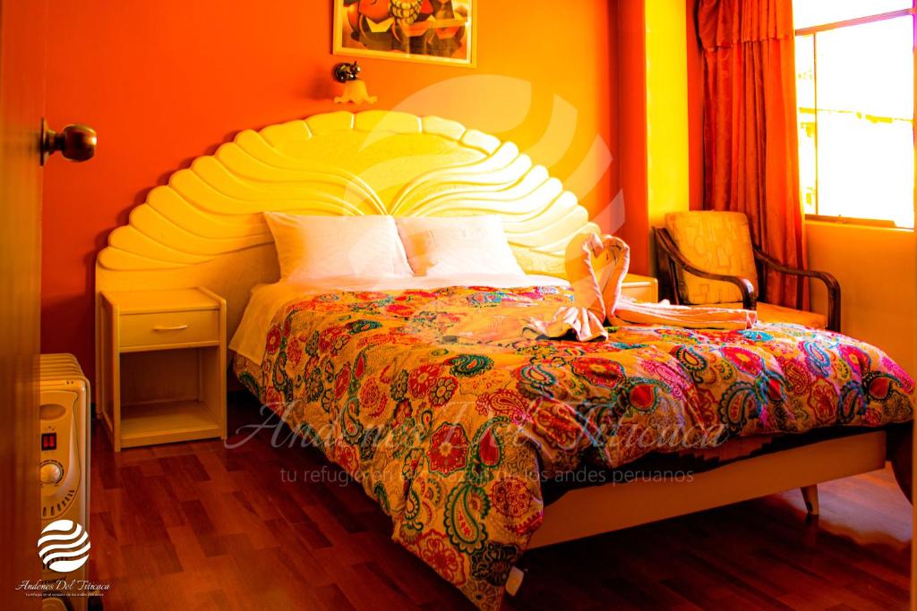 a bedroom with a large bed with a colorful bedspread at PUNO ANDENES Suite in Puno
