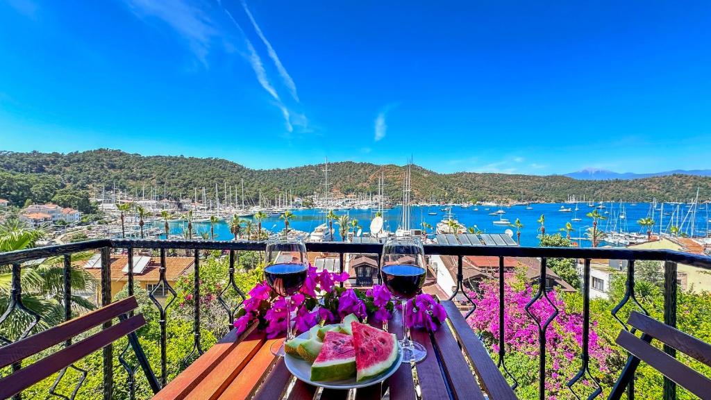 two people sitting at a table with a plate of watermelon at Mykonut Boutique Suites in Fethiye