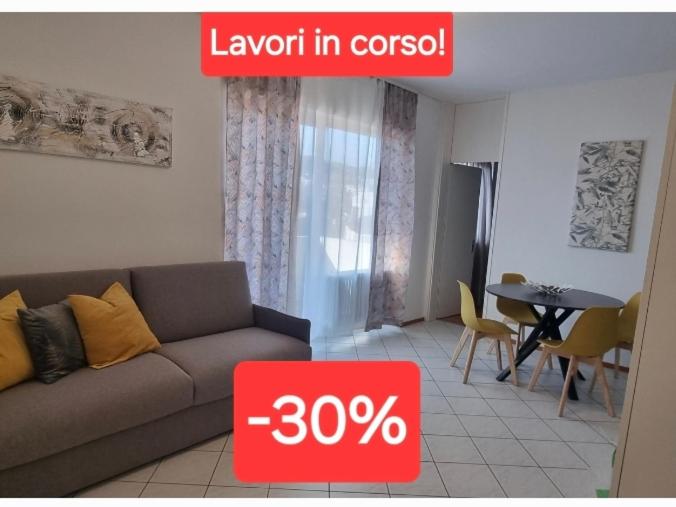 a living room with a couch and a table at Al Nido Della Stazione in Lugano