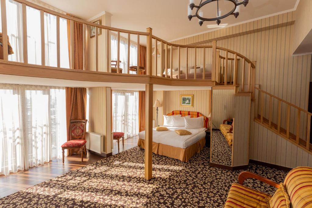 a bedroom with a bed and a spiral staircase at Shirak Hotel in Yerevan