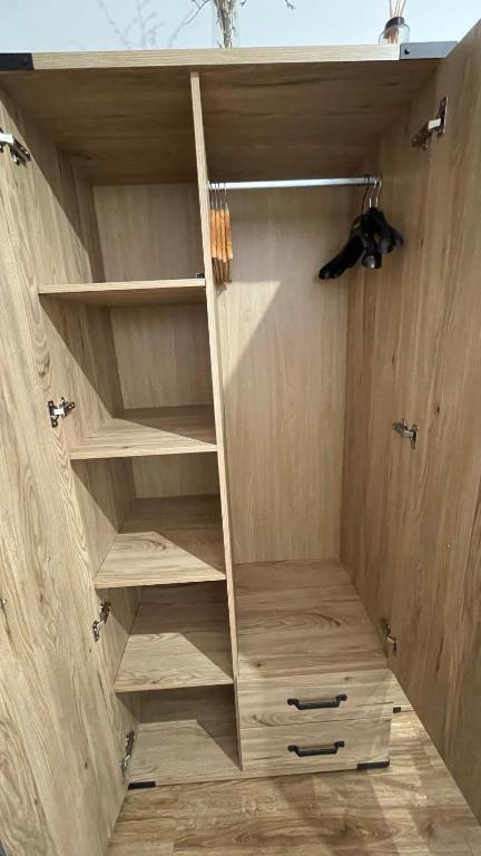 a closet with wooden shelves in a room at Gdynia Riviera Hills in Gdynia