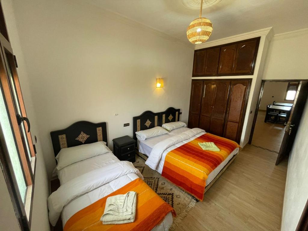 Voodi või voodid majutusasutuse Merzouga Lodge toas