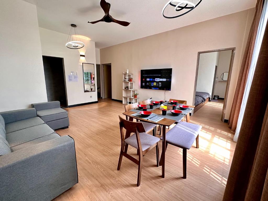 a living room with a table and a couch at Emerald Avenue Brinchang Muji style in Brinchang