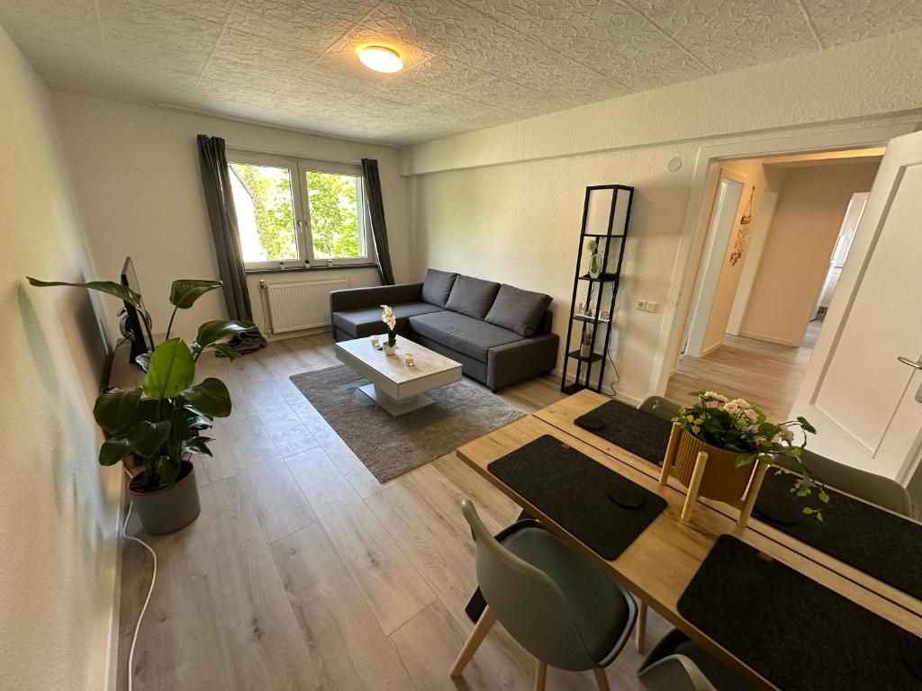 a living room with a couch and a table at Moderne Ferienwohnung für 4-5 Personen mitten in Herten*Netflix*Nespresso in Herten