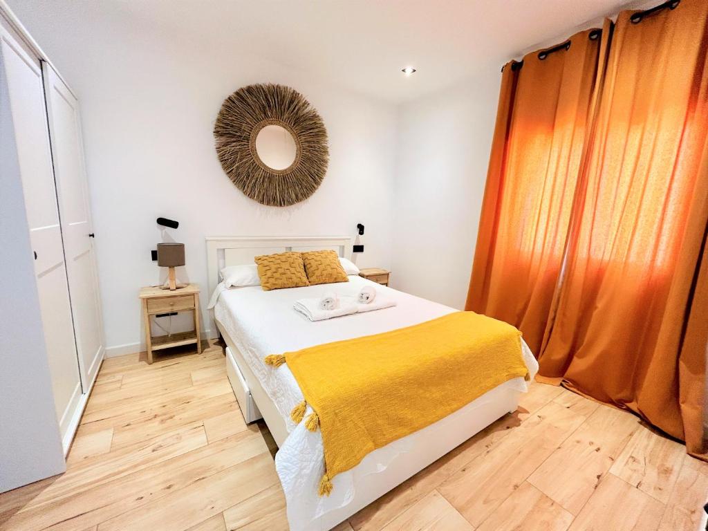 a bedroom with a bed with a yellow blanket on it at Ecochic Apartment in Fuengirola Center in Fuengirola