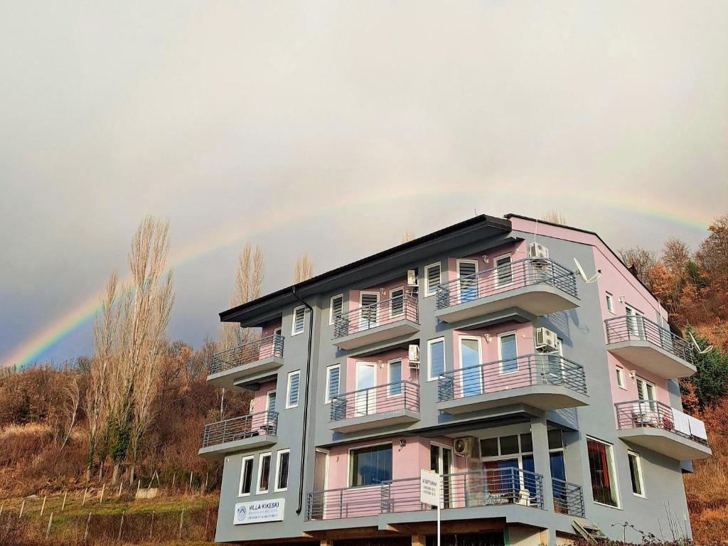 a rainbow in the sky above a building at Vila Kikeski in Elshani