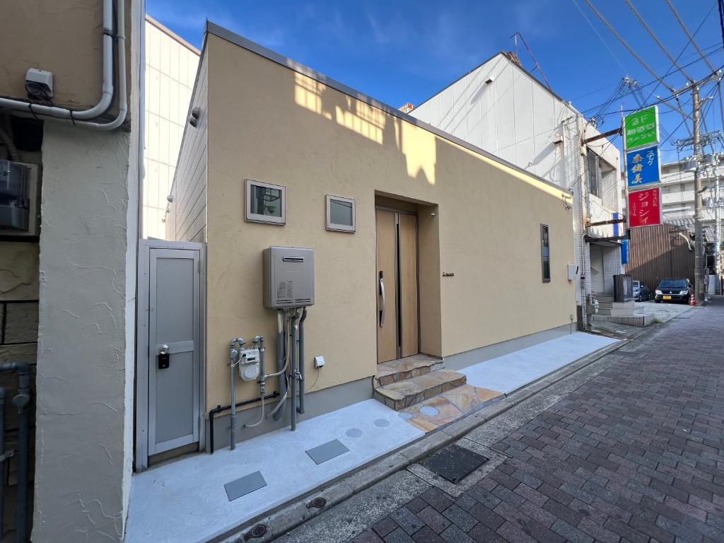 a building with a door on the side of a street at Dia INN in Sumoto