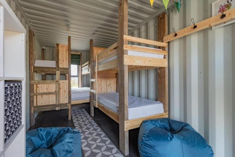 a room with two bunk beds in a house at 11 Bee Hive, Camp Tapnell in Yarmouth