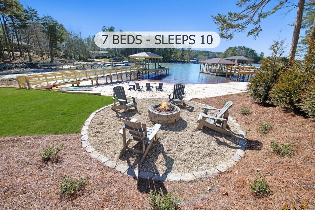 a patio with chairs and a fire pit next to the water at Blarney Bay in Mooresville