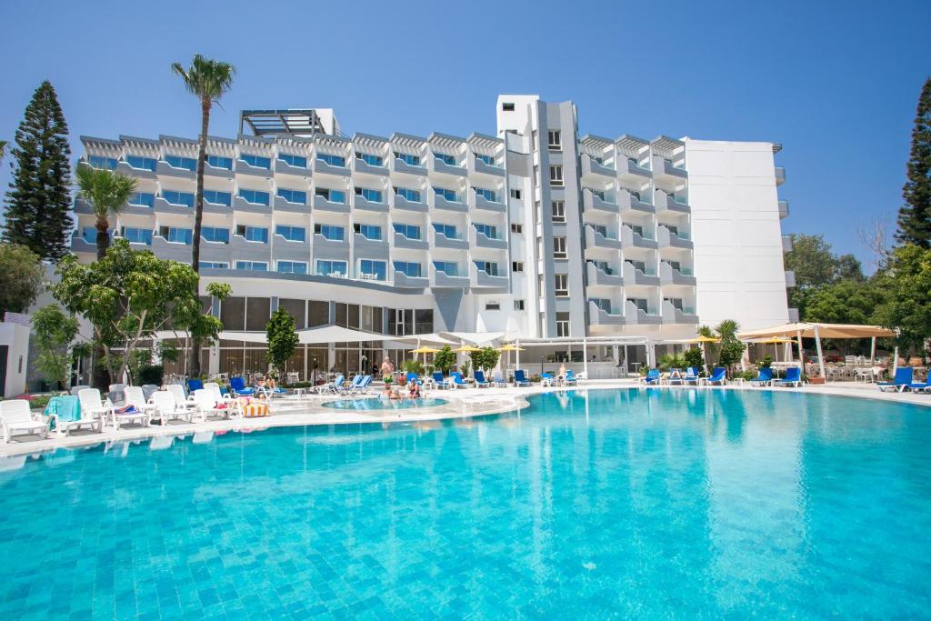 a large swimming pool in front of a hotel at Papouis Protaras Hotel in Protaras