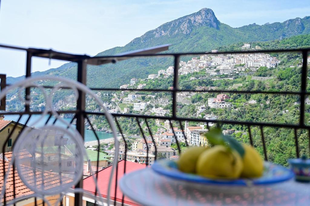 a plate of bananas on a table on a balcony at Armarì Panoramic Flat in Vietri