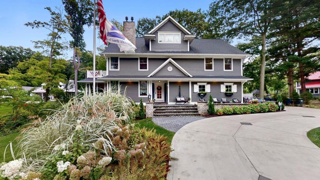 a gray house with an american flag on it at Fern Creek in South Haven
