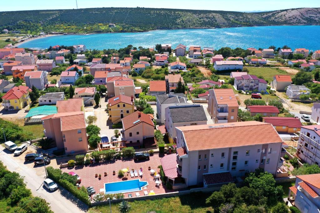 an aerial view of a small town next to the water at Apartments Cimbal in Stara Novalja