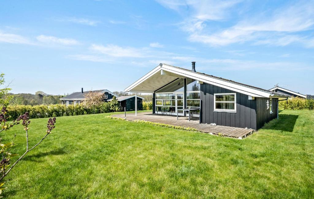 a black house with a large yard at Stunning Home In Frørup With Kitchen in Frørup
