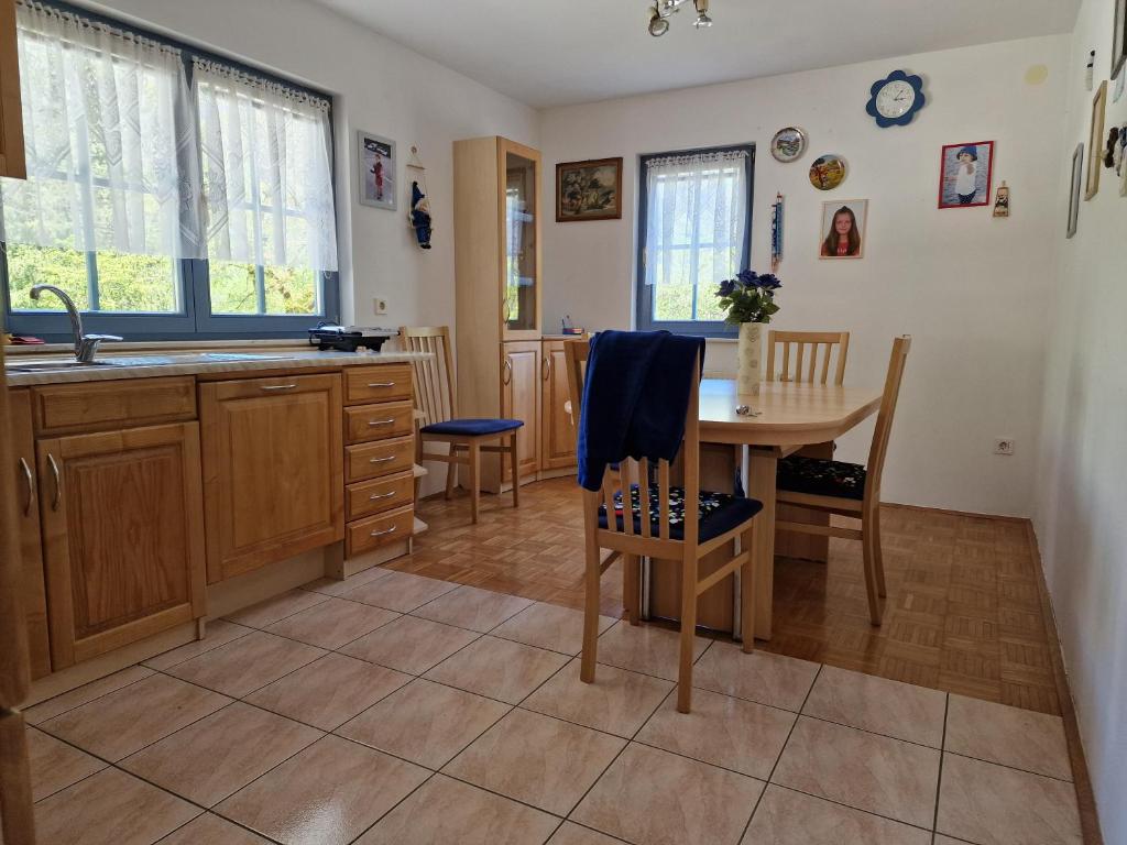 a kitchen with a table and chairs and a sink at Apartment Luka at Soča & Koritnica confluence in Bovec