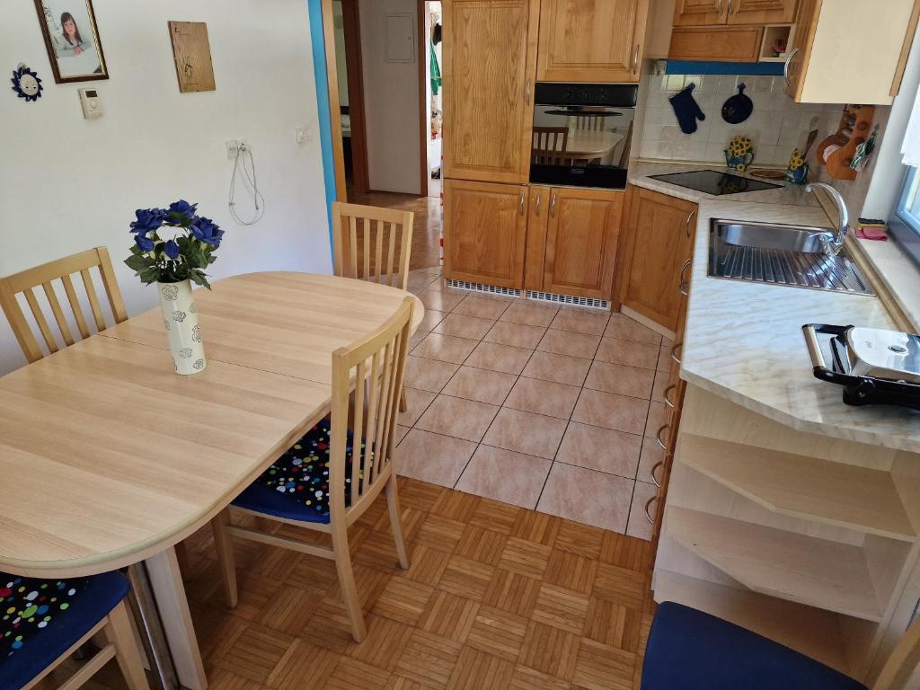 a kitchen with a table with a vase of flowers on it at Apartment Luka at Soča & Koritnica confluence in Bovec