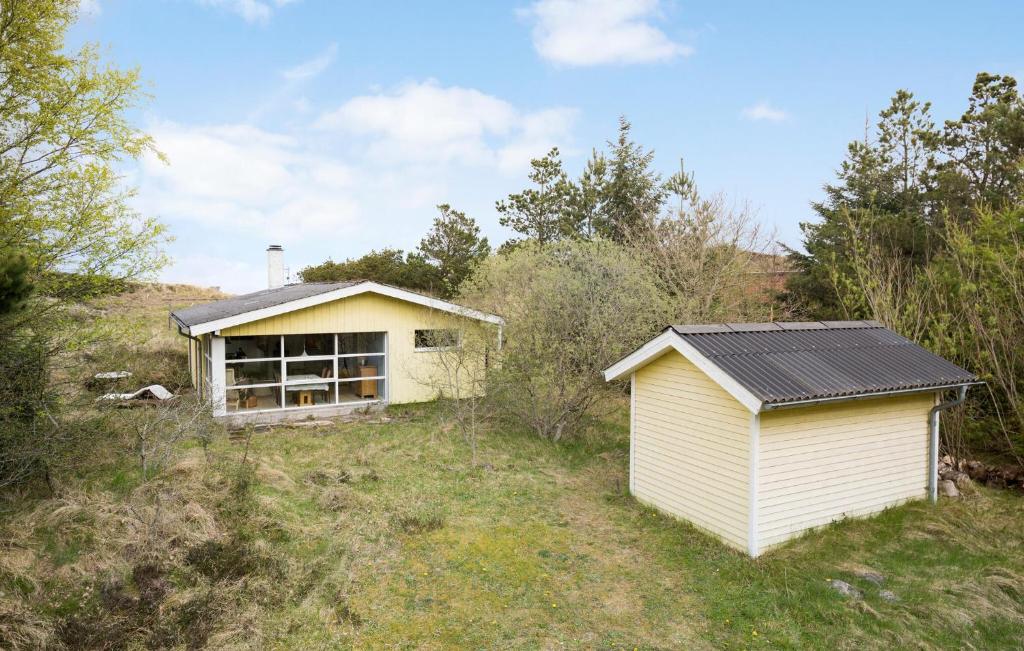 a small house in the middle of a field at 2 Bedroom Nice Home In Fjerritslev in Fjerritslev