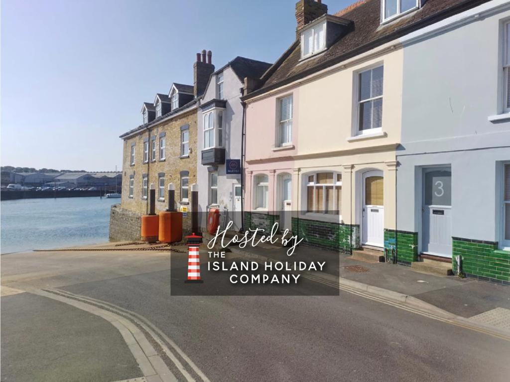 a sign that reads the island holiday company at Chic Listed House with Harbour and River Views in Central Cowes - Walk to top restaurants in East Cowes