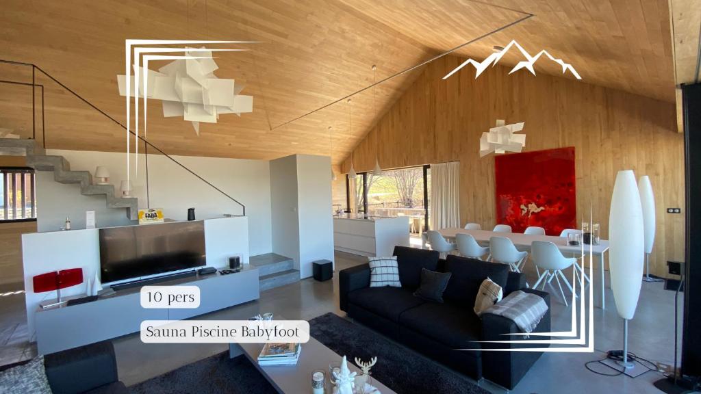 a living room with a couch and a tv at Chalet Evolena in Guillestre