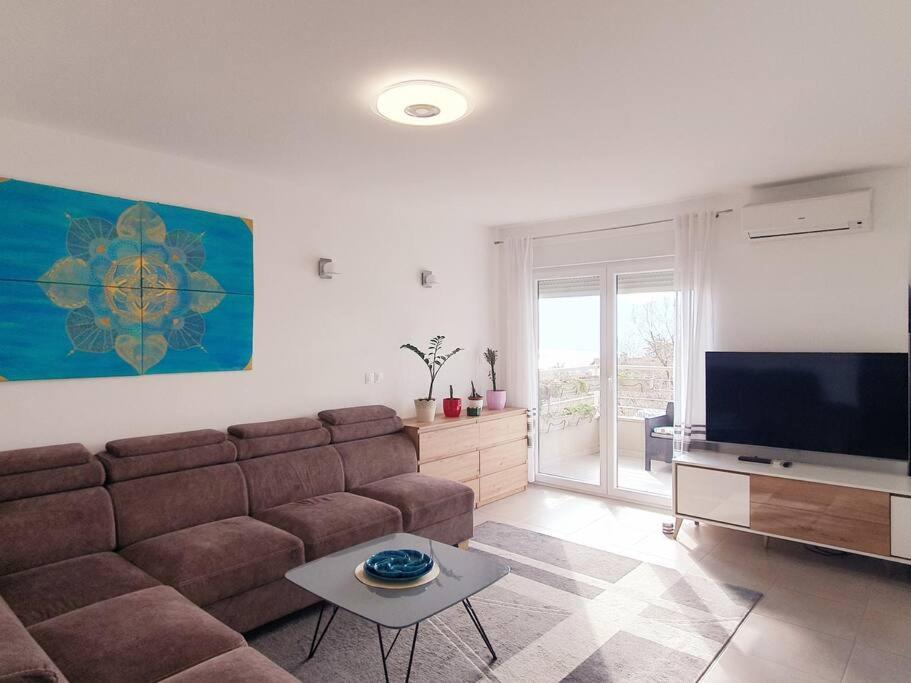 a living room with a couch and a flat screen tv at Apartment Felix in Rijeka