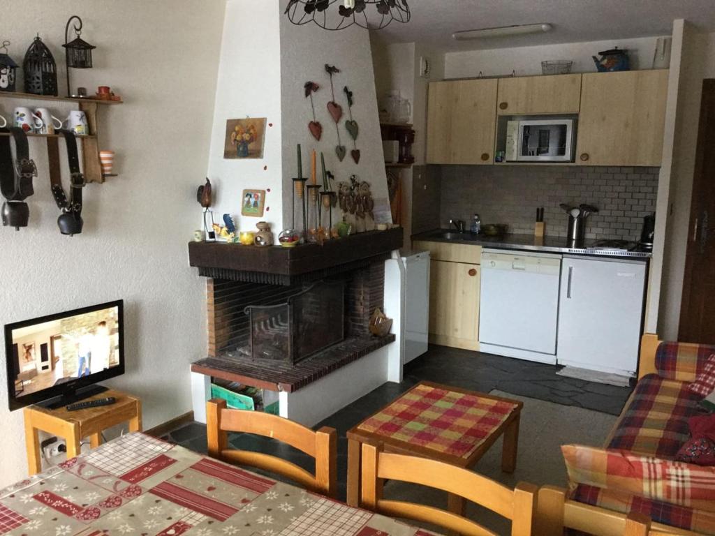 a kitchen and a living room with a fireplace at Appartement Châtel, 3 pièces, 6 personnes - FR-1-676-52 in Châtel