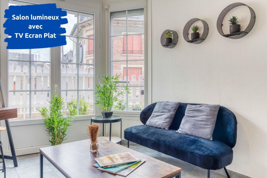 un salon avec un canapé bleu et une table dans l'établissement Golden Bridge - Confort - Calme - Centre, à Abbeville