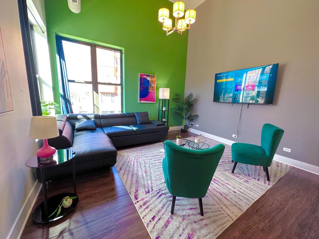 a living room with green walls and a couch and chairs at McCormick Place 3BR-2BA unit with Optional Parking - sleeps 8 in Chicago