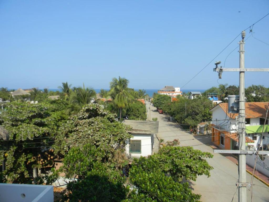 a view of a street in a town with trees at Casa Vista Al Mar - Iguana Room in Puerto Escondido