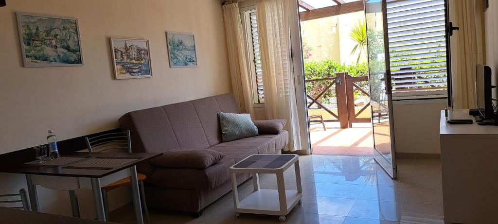 a living room with a couch and a table at Apartment Los Hibiscos in Costa Calma