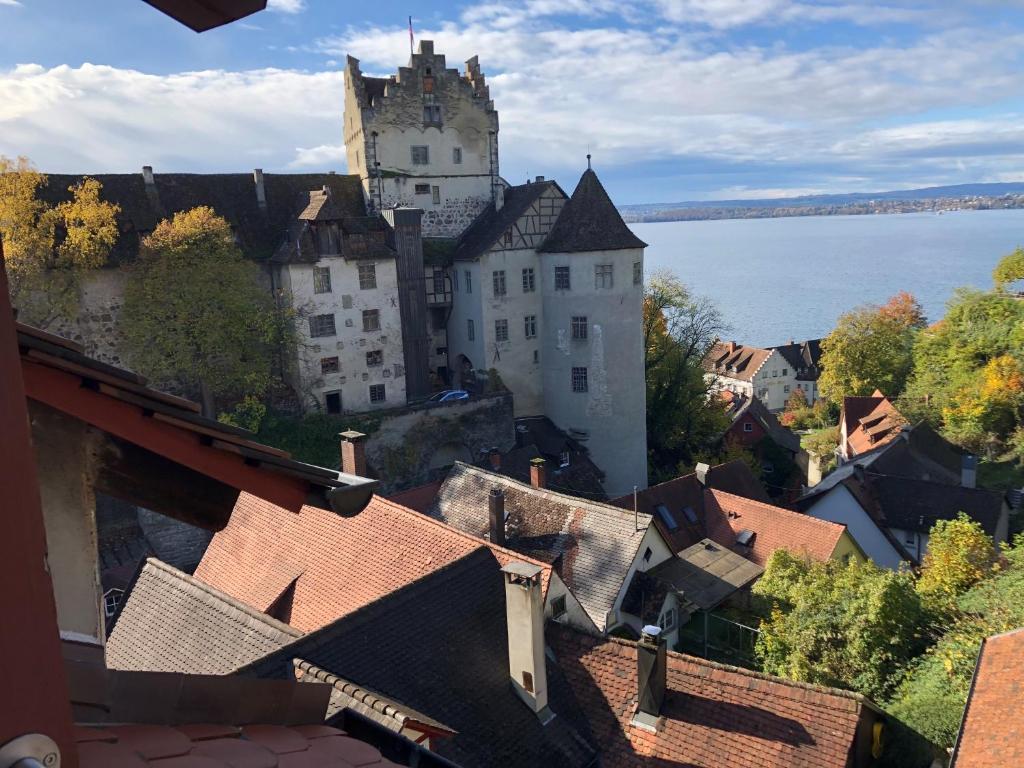 a view of a town with a castle in the distance at Winzerhäusle Meersburg in Meersburg