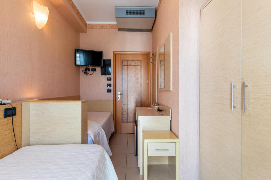 Postel nebo postele na pokoji v ubytování Hotel Metropole
