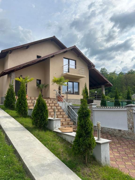 a house with stairs in front of it at Pensiunea Melissa in Malaia