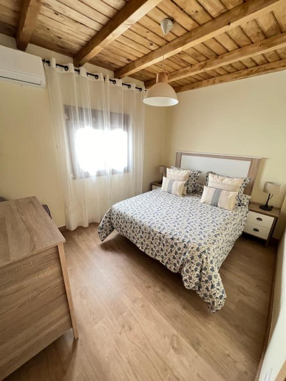 1 dormitorio con cama y ventana en Casa Rural Casa Isabel, en Hervás