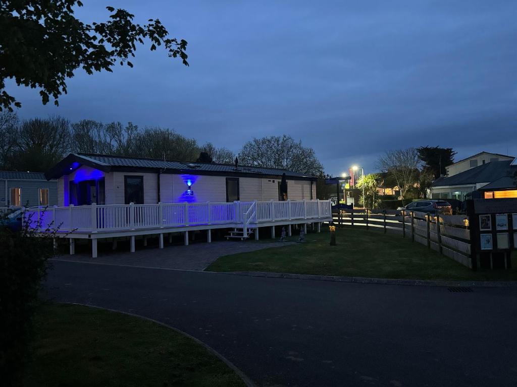 a house with blue lights on the side of it at Jasmine lodge in Overcombe