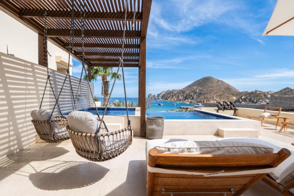 a patio with hammocks and a view of the ocean at 1 Homes Preview Cabo in Cabo San Lucas