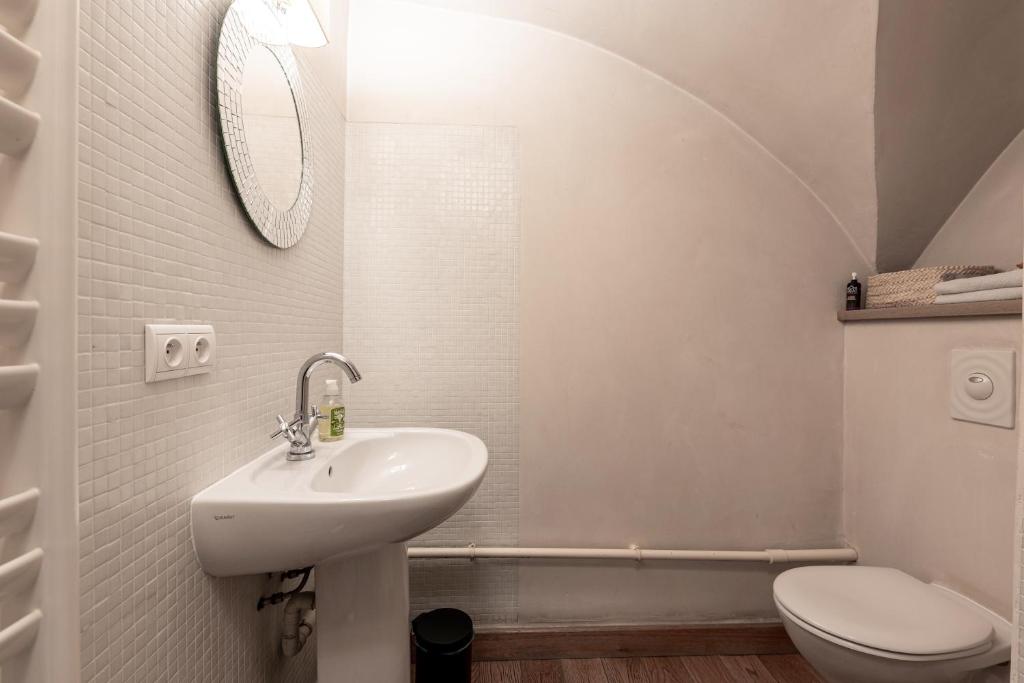 a white bathroom with a sink and a toilet at Bed end breakfast du centre in Bourg-Saint-Maurice