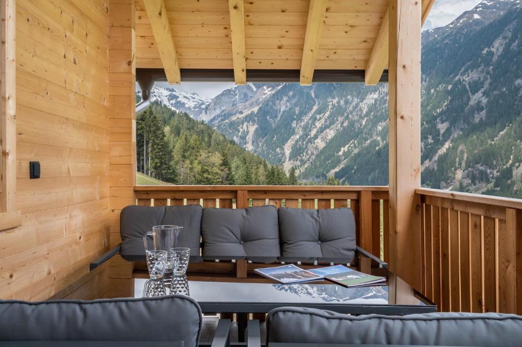 a room with a table and a view of mountains at Blosegghof Bergchalets Himmelblick in Racines