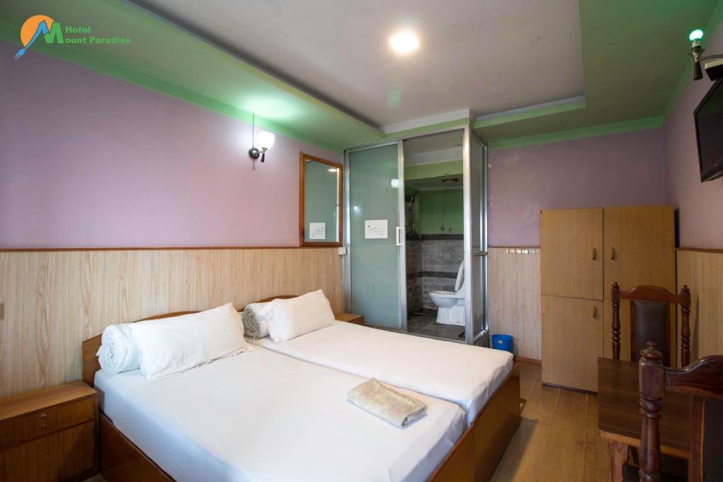 Postel nebo postele na pokoji v ubytování Hotel Mount Paradise